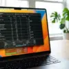 Tampilan layar MacBook Pro dengan grafik performa dari Activity Monitor